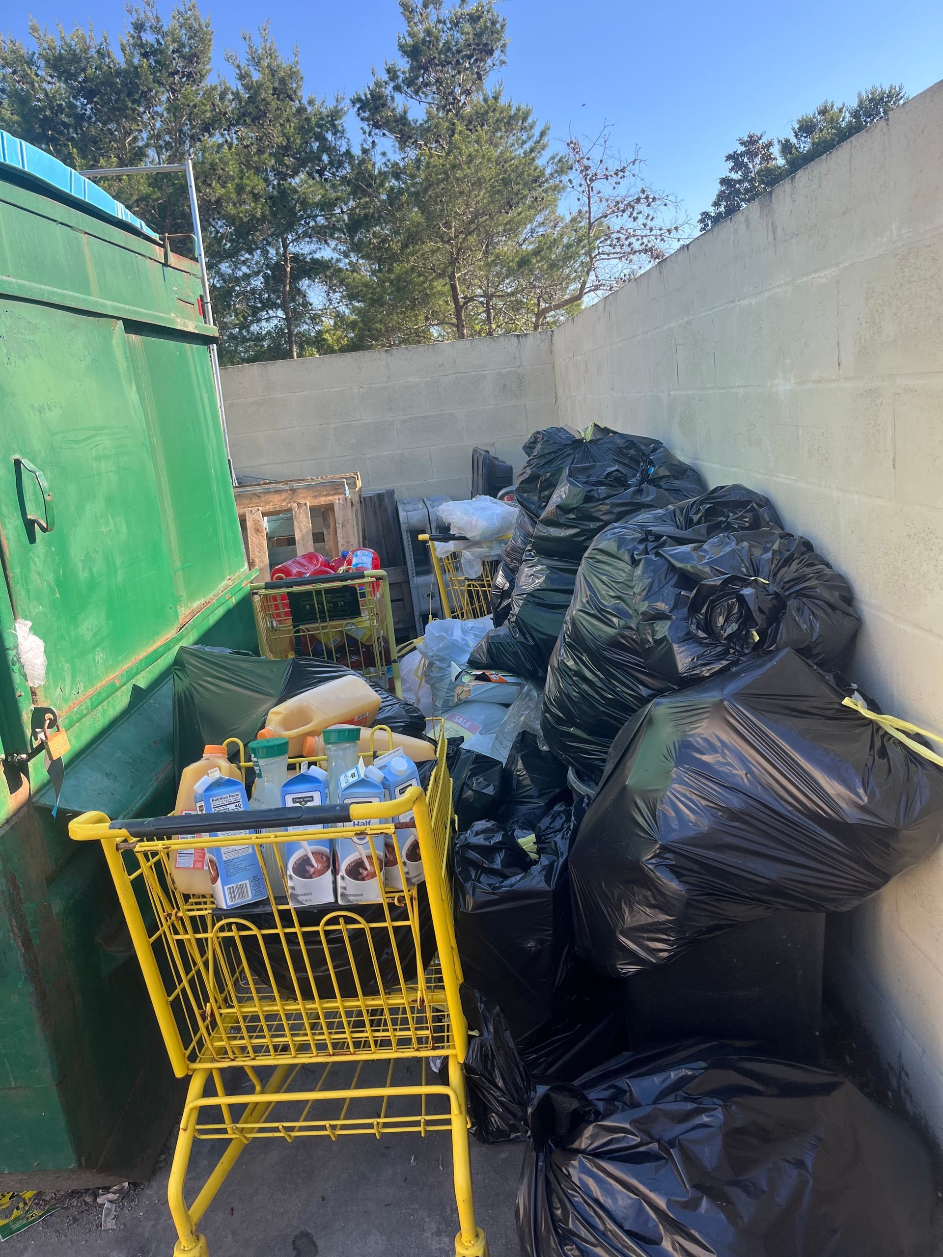 A yellow shopping cart is filled with bottles of water