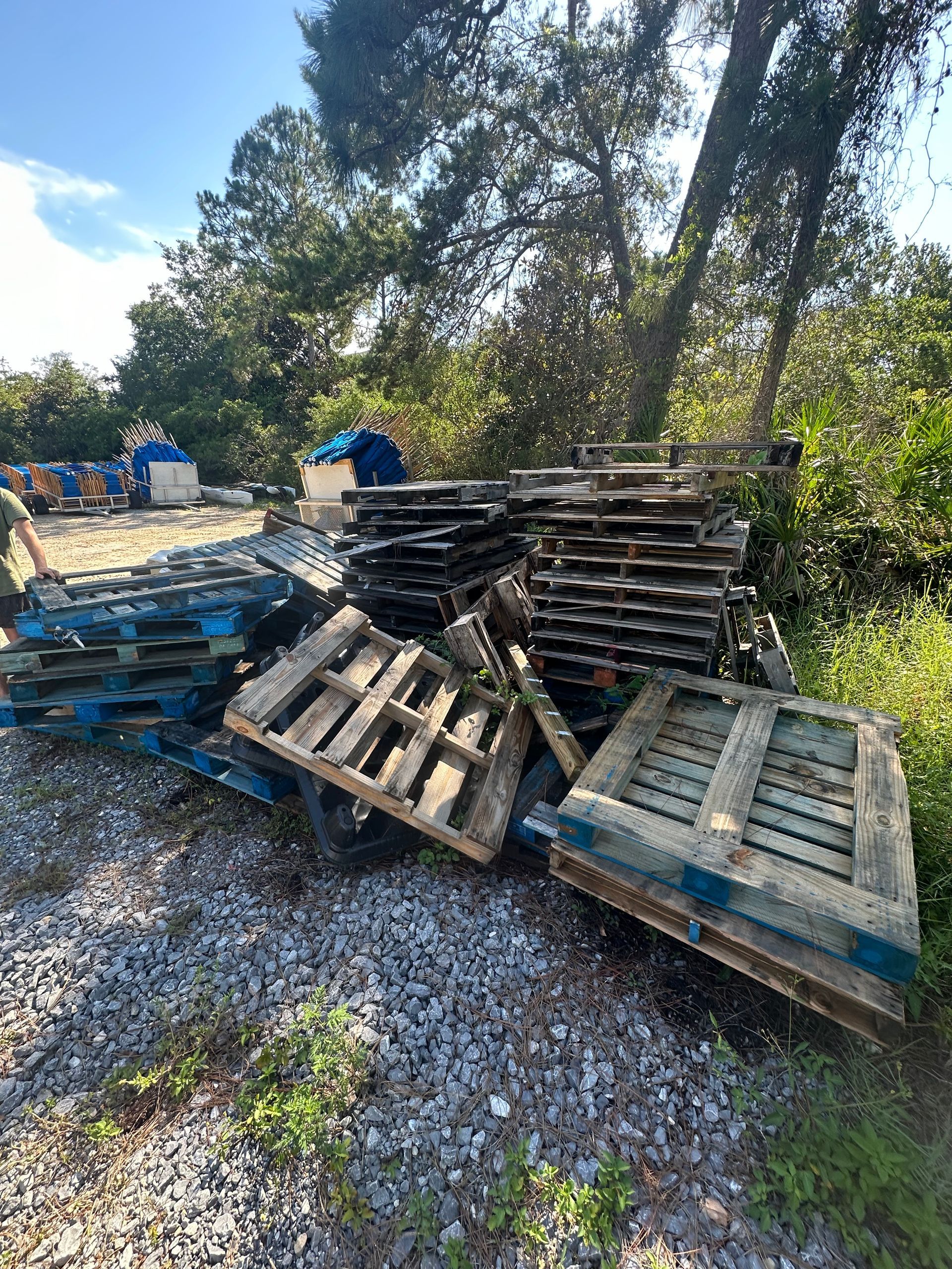 Stack of old wooden pallets and job-site scrap, construction debris removal for new builds in Crestview, FL