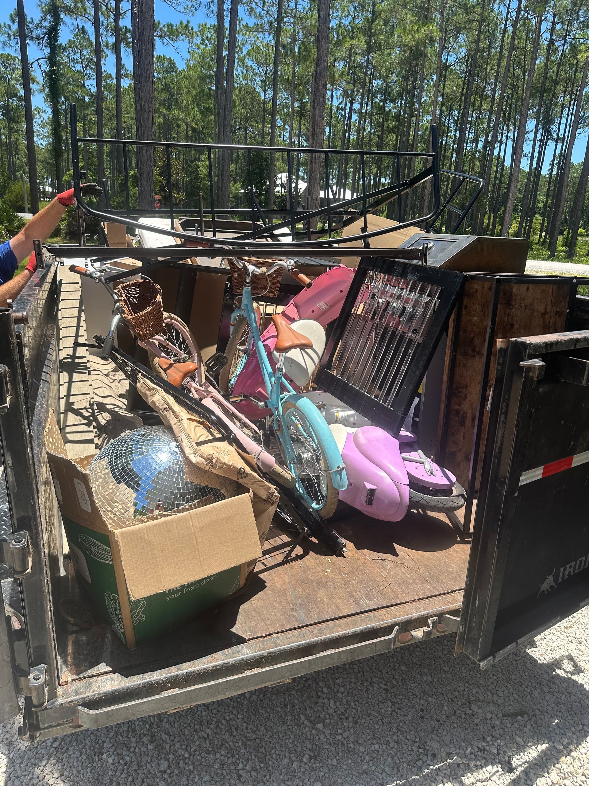 A dumpster filled with lots of trash and junk.