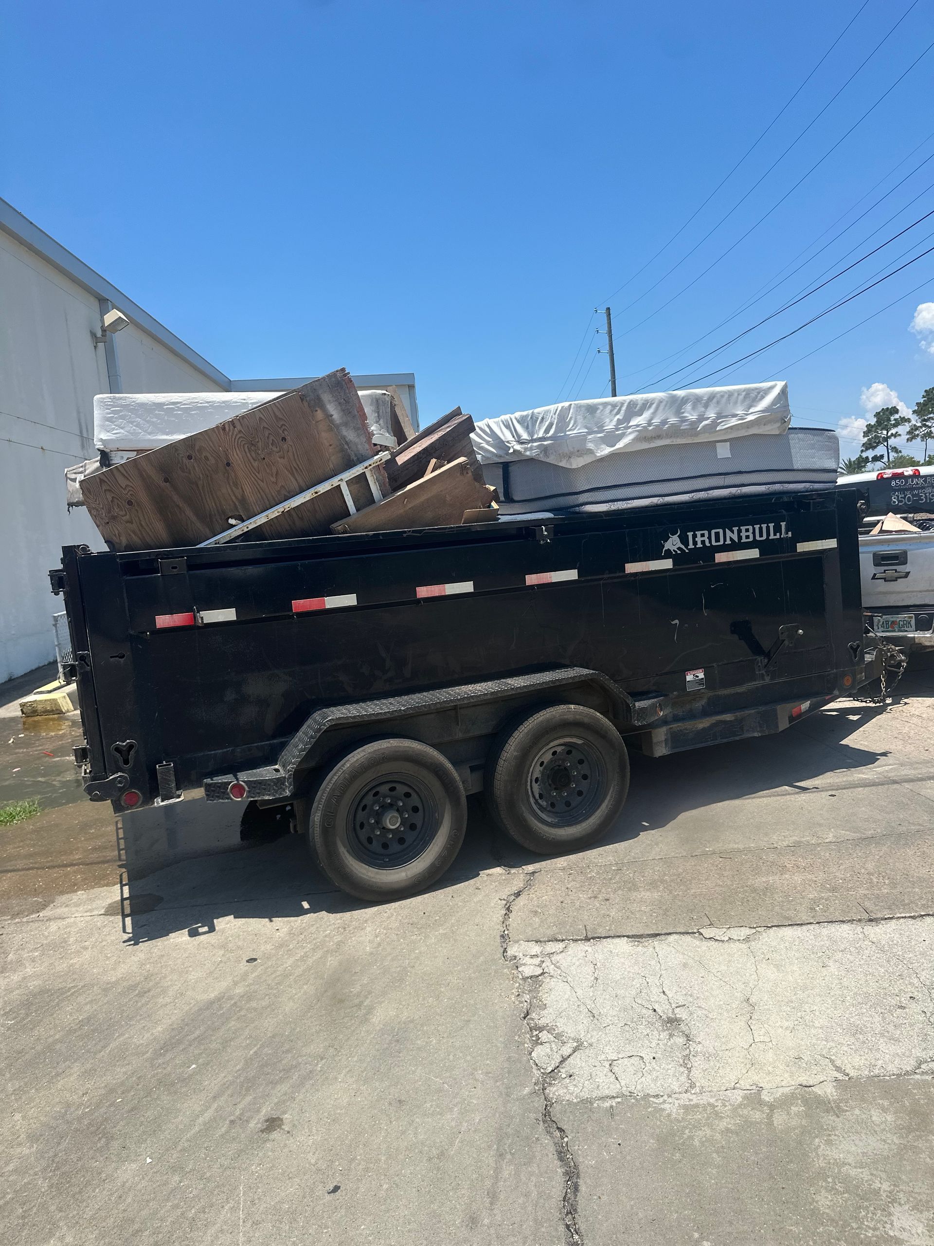 Dump trailer loaded with old furniture, PCS furniture removal for Eglin AFB and Hurlburt Field families, FL