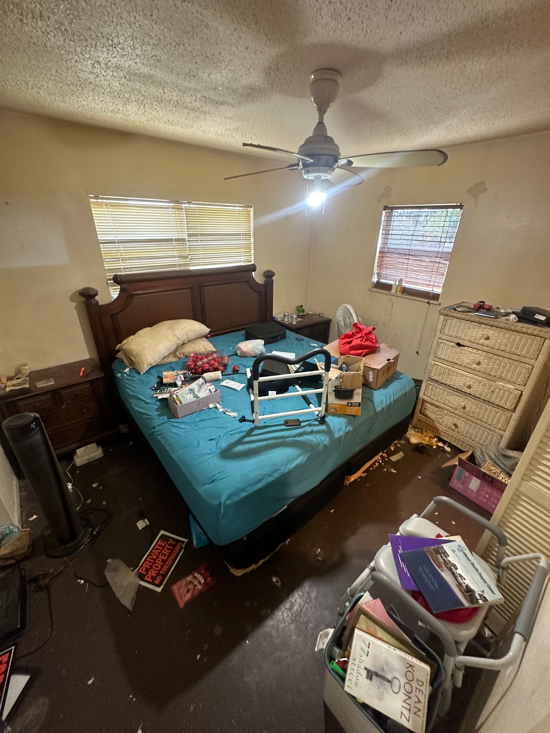 A bedroom with a bed , dresser , nightstand and ceiling fan.