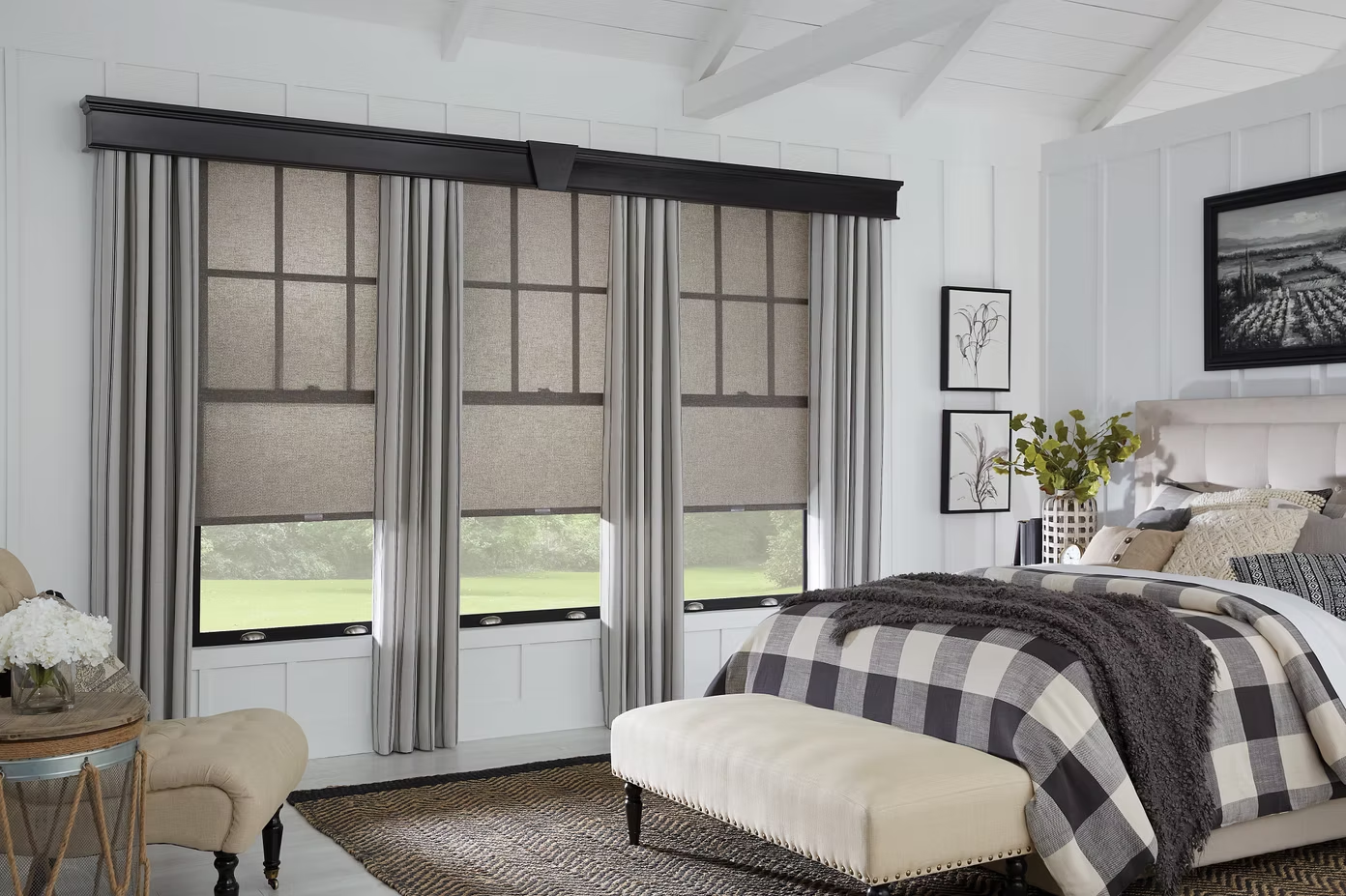 Bright bedroom with gray curtains, a plaid bed, and a large window with frosted panes