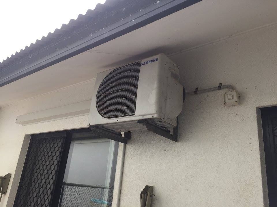 White Air Conditioning Unit Mounted on an Exterior Wall — Active Airconz in Mackay, QLD