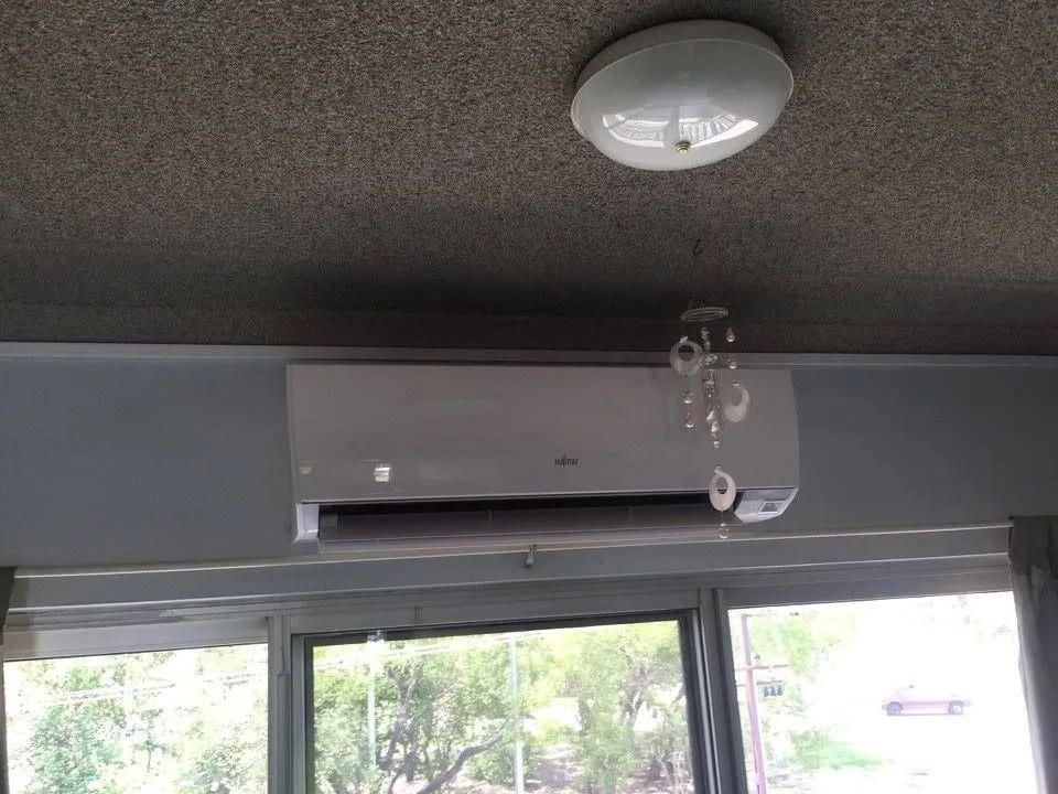 White Wall-mounted Air Conditioning Unit Above a Window — Active Airconz in Nhulunbuy, NT