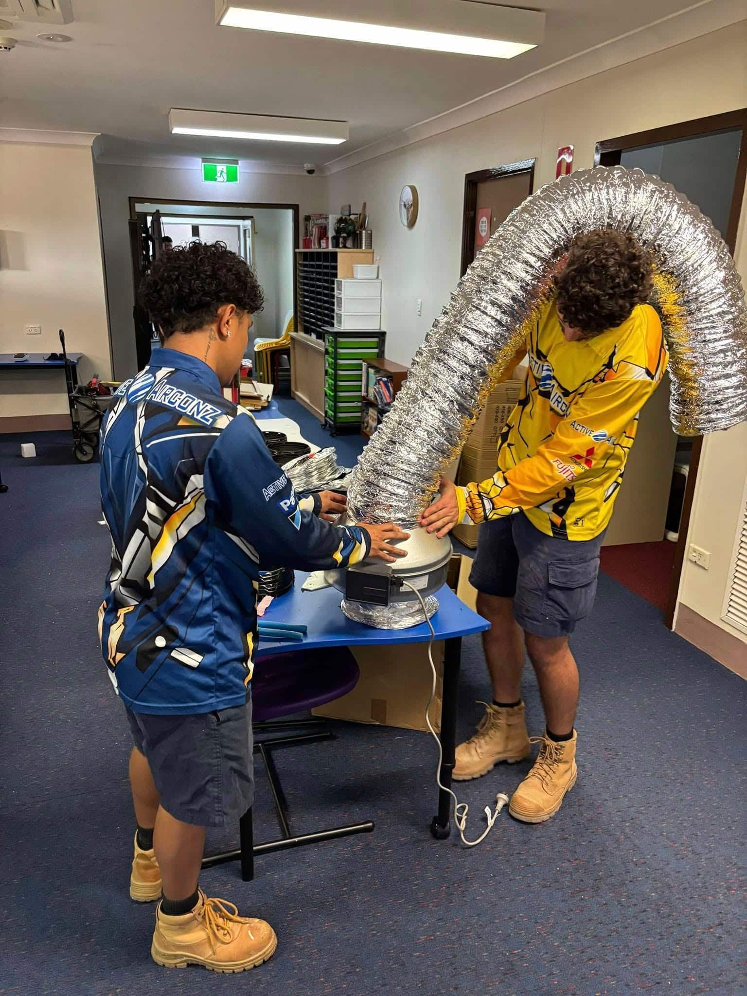 Two People Working With Ducting in a Room — Active Airconz in Cairns, QLD