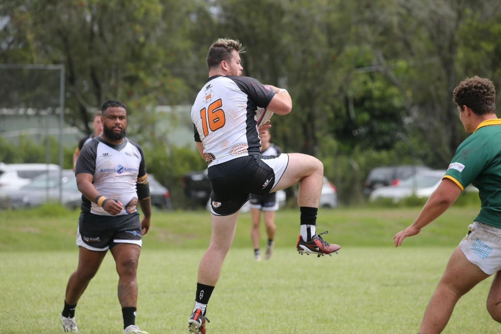 Rugby Player in White and Black Jumps to Catch the Ball — Active Airconz in Winnellie, NT