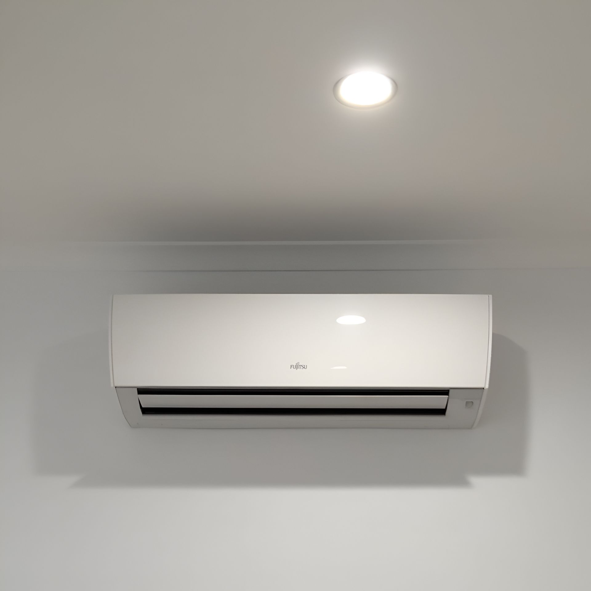 White Air Conditioner Mounted on a Gray Wall — Active Airconz in Winnellie, NT