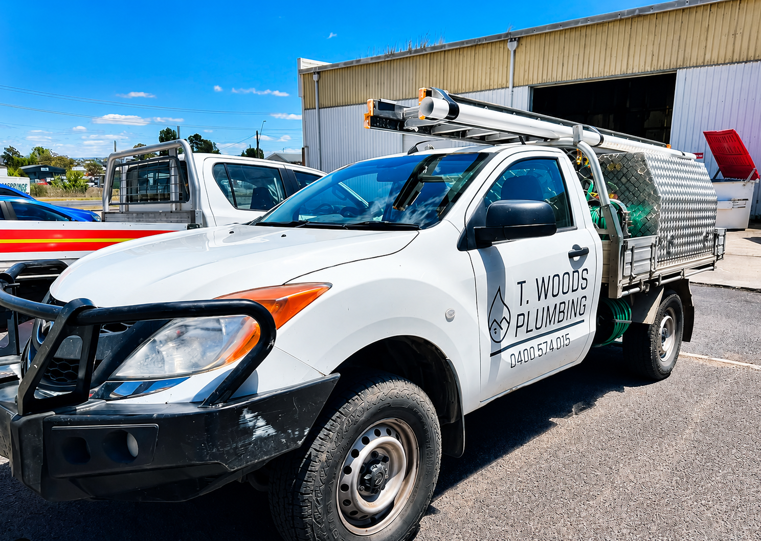 Hand Repairing a Leaking White Pipe With a Red Power Tool — T. Woods Plumbing in Bathurst, NSW