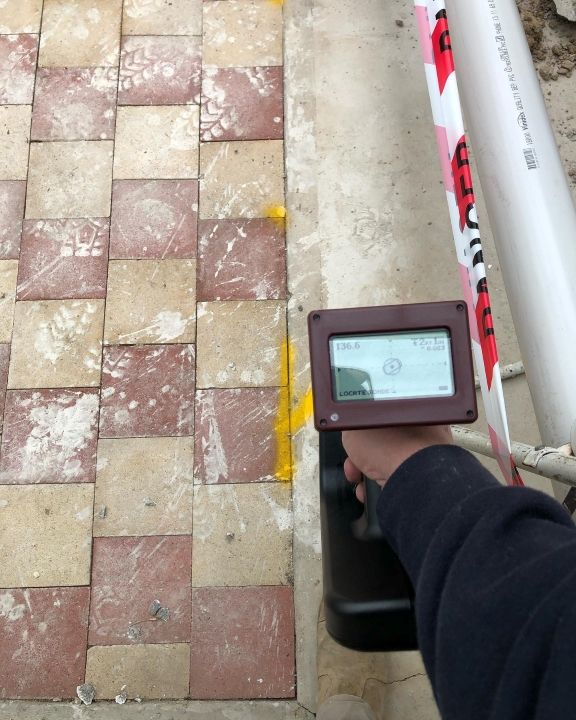 A Person is Holding a Device in Front of a Pipe — T. Woods Plumbing in Bathurst, NSW