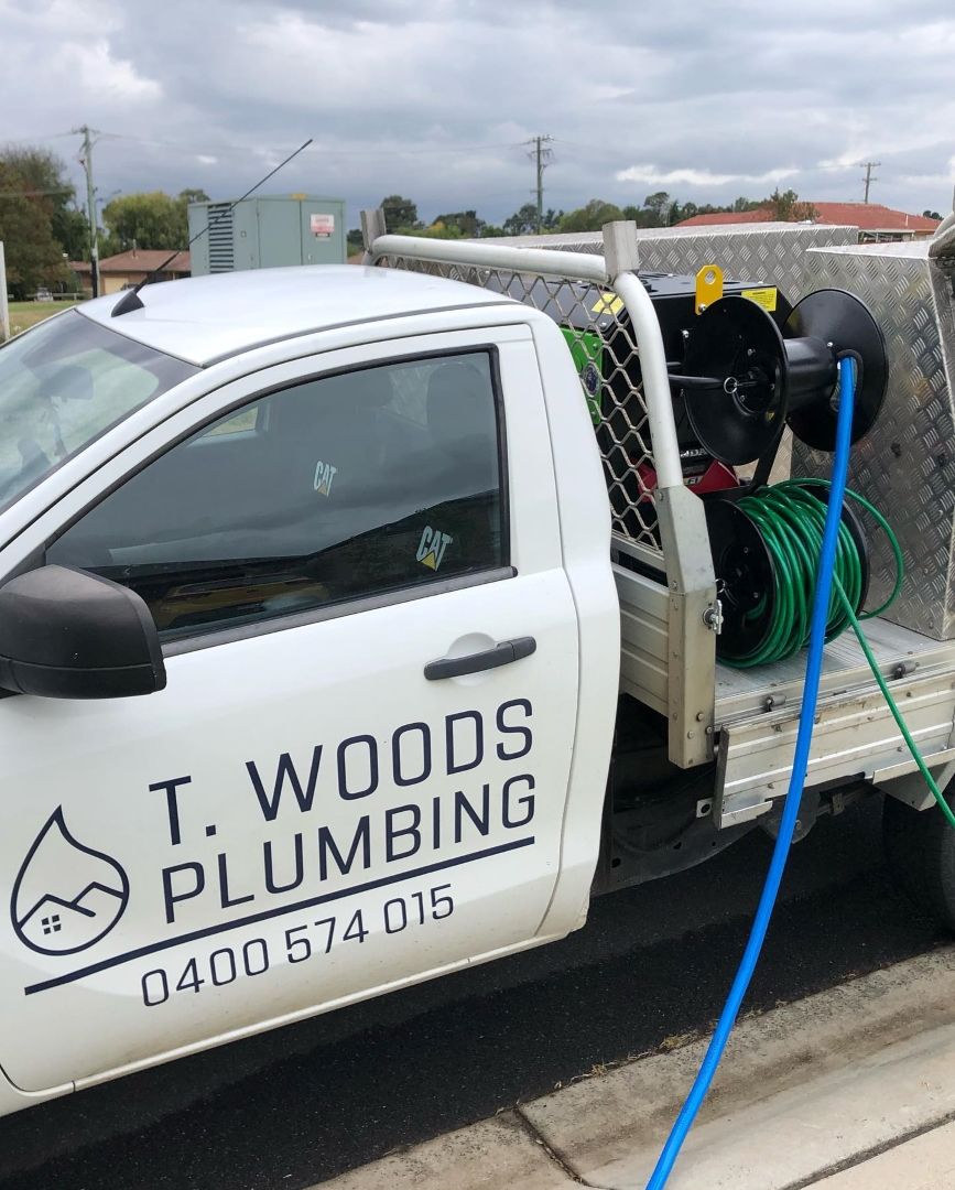 A T. Woods Plumbing Truck is Parked on the Side of the Road — T. Woods Plumbing in Bathurst, NSW