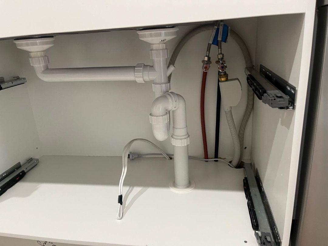 Under-Sink Plumbing With White Pipes in Bathurst