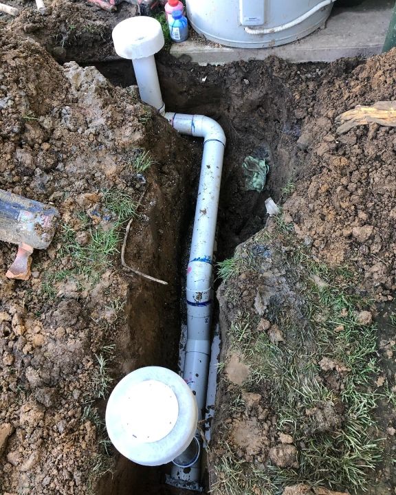A Pipe is Being Installed in a Hole in the Ground — T. Woods Plumbing in Bathurst, NSW