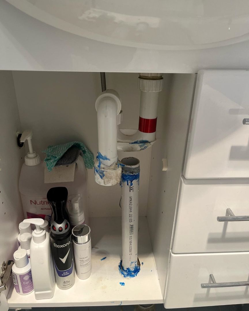 A Bathroom Sink With a Drain Pipe Underneath It — T. Woods Plumbing in Bathurst, NSW