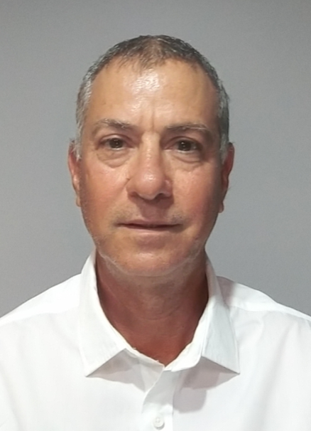 Man wearing a white shirt, looking at the camera. Neutral expression against a light gray background.