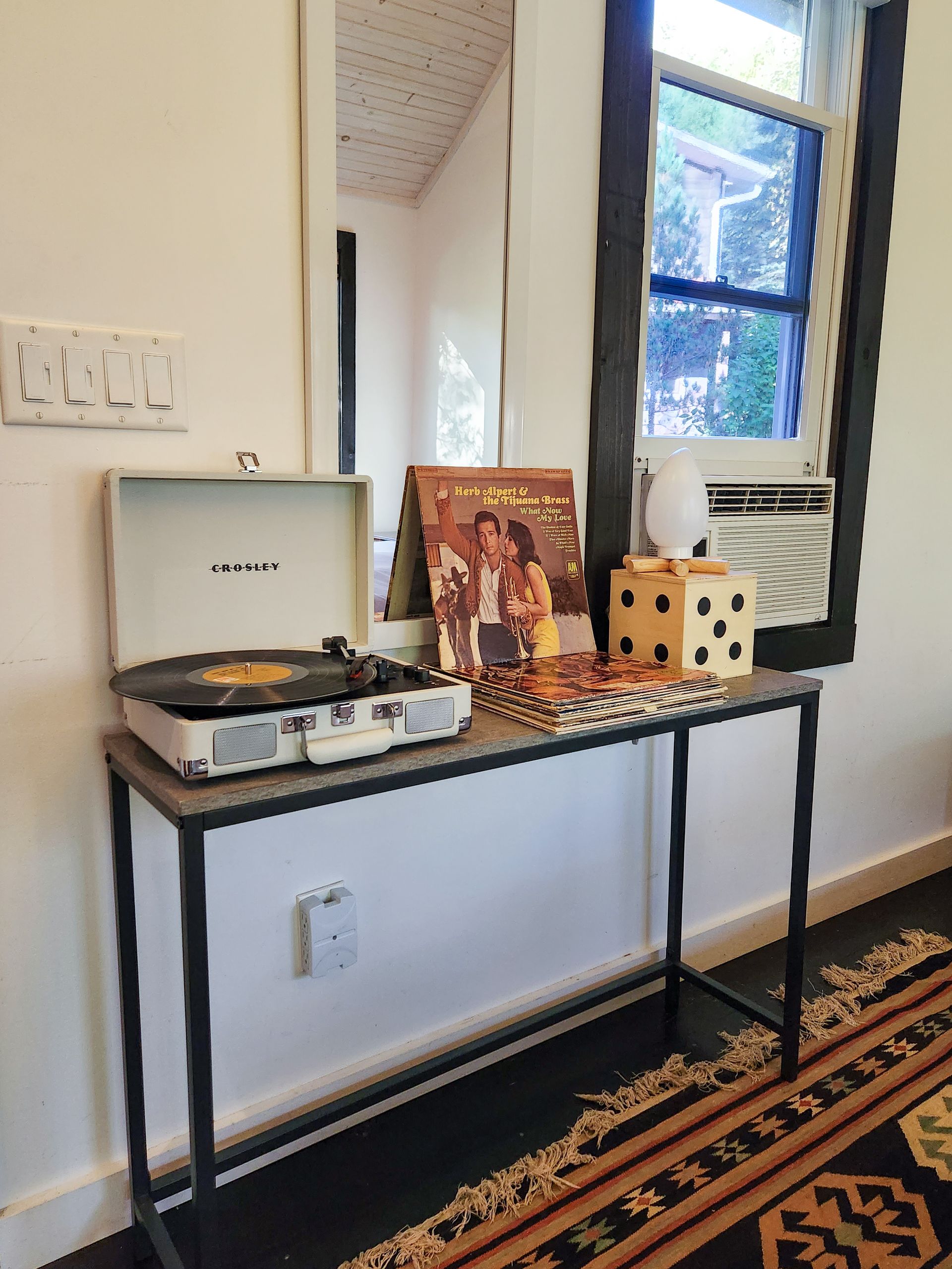 Interior of Cabin 1, Belleayre Lodge's hotel-style cabin, showing turntable and vinyl LP's on a shelf.