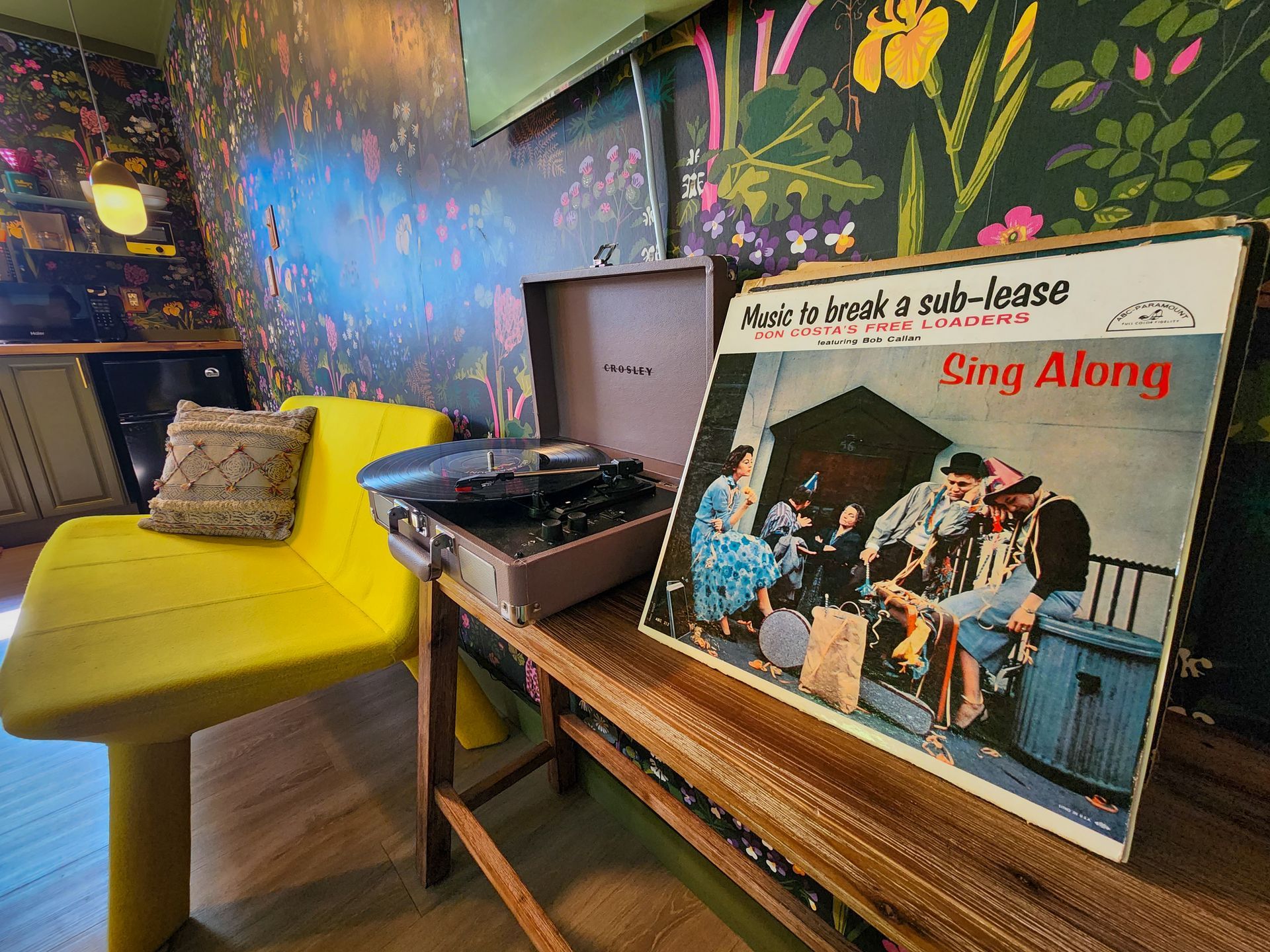 Interior of Belleayre Lodge Cabin #2, showing a turntable with LP next to yellow sofa.