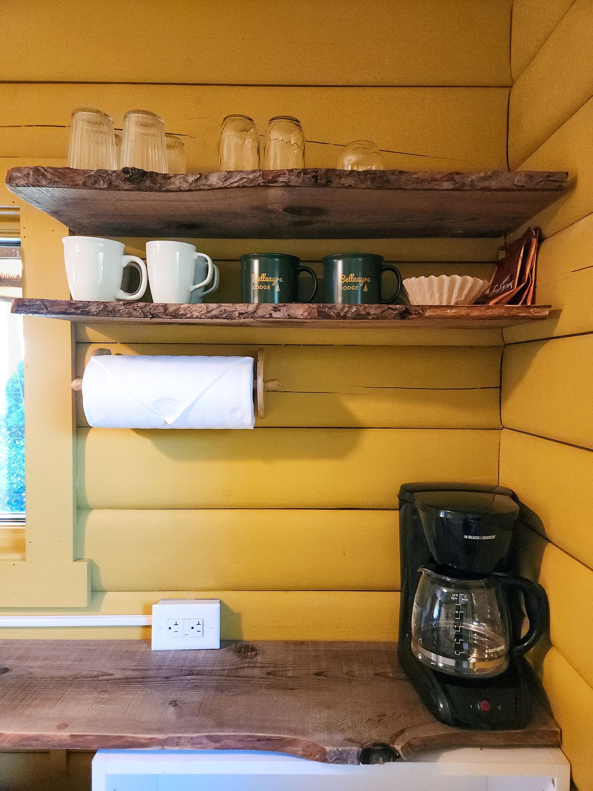 Closeup of Kitchen at Cabin #4A at Belleayre Lodge in the Catskills, showing shelf with coffee maker and branded mugs.