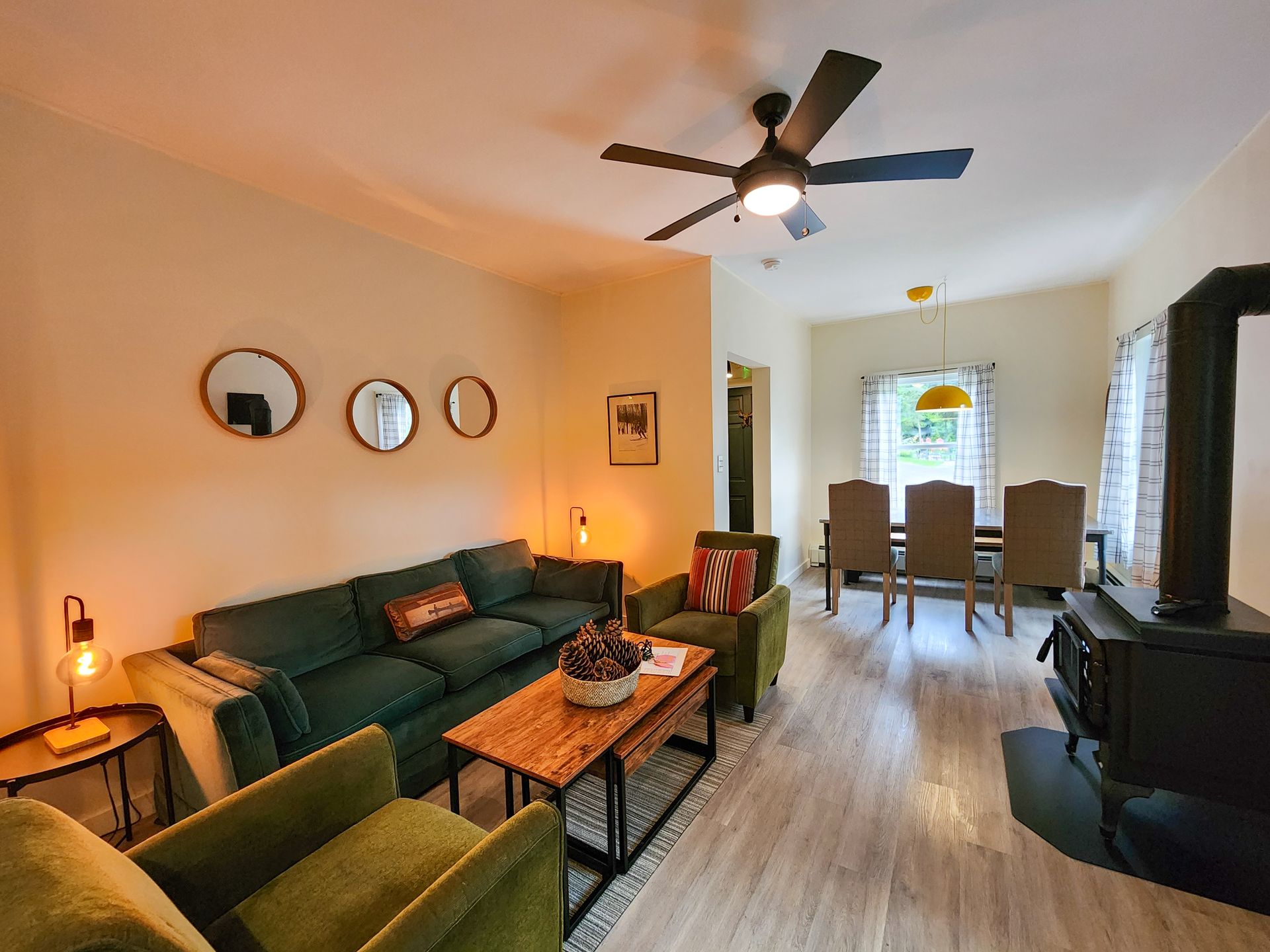 Living room space of Cabin #9 at Belleayre Lodge in the Catskills, showing sofa, tables, chairs, gas fireplace.