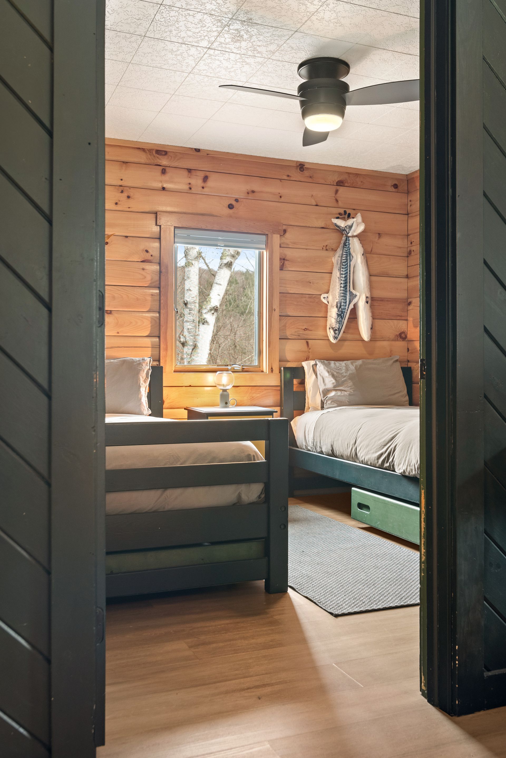 Cozy bedroom for Cabin 4A in Belleayre Lodge in Pine Hill, NY - showing two beds and Catskill views out the windows