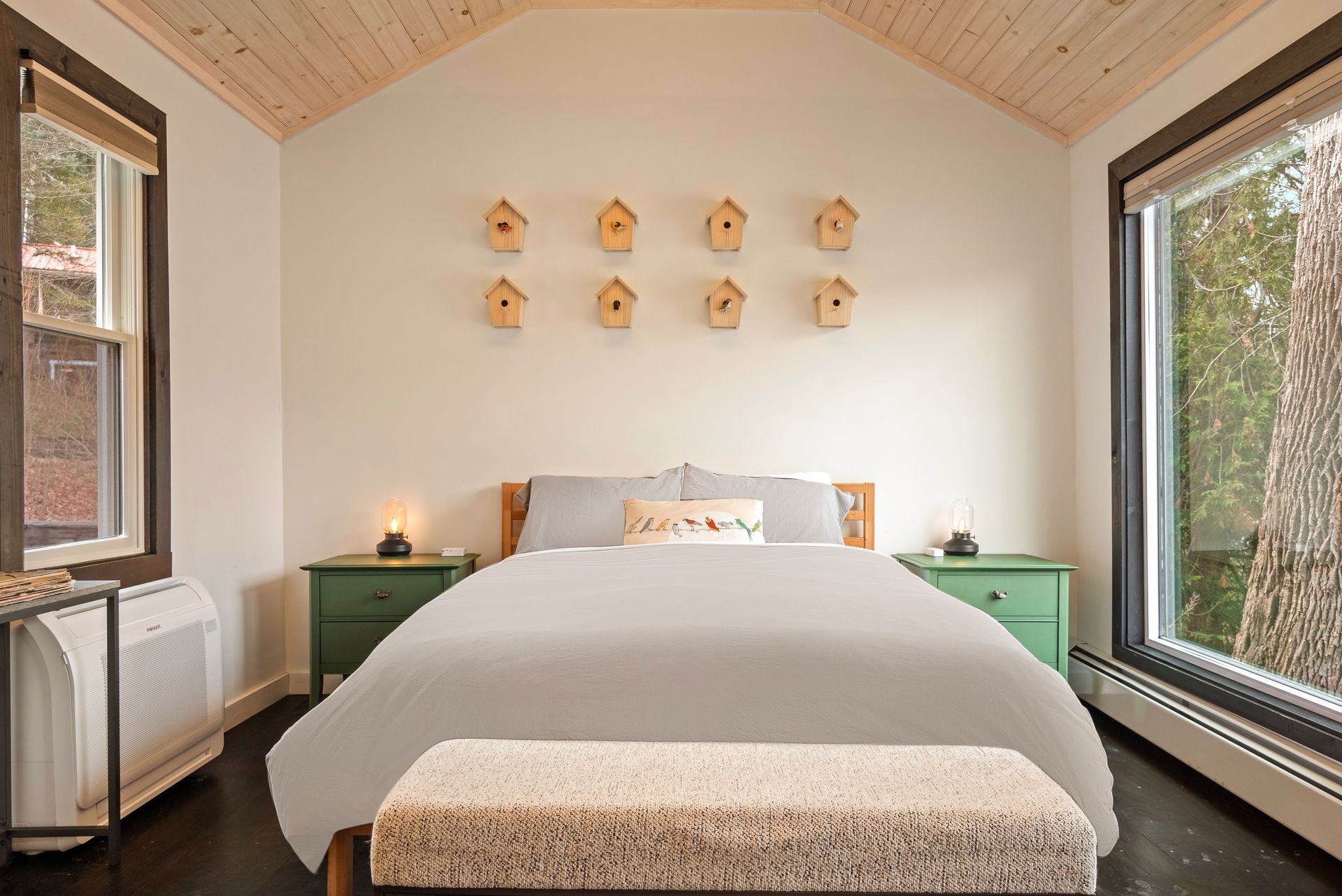 Interior of Cabin 1 at Belleayre Lodge of Pine Hill NY, showing comfortable queen bed and Catskill views out the window.