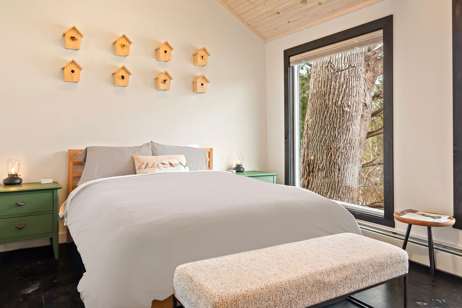 Interior of Cabin 1 at Belleayre Lodge of Pine Hill NY, showing comfortable queen bed and Catskill views out the window.