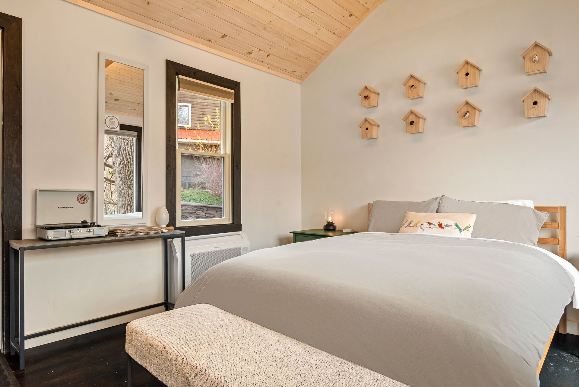 Interior of Cabin 1 at Belleayre Lodge of Pine Hill NY, showing comfortable queen bed and Catskill views out the window.