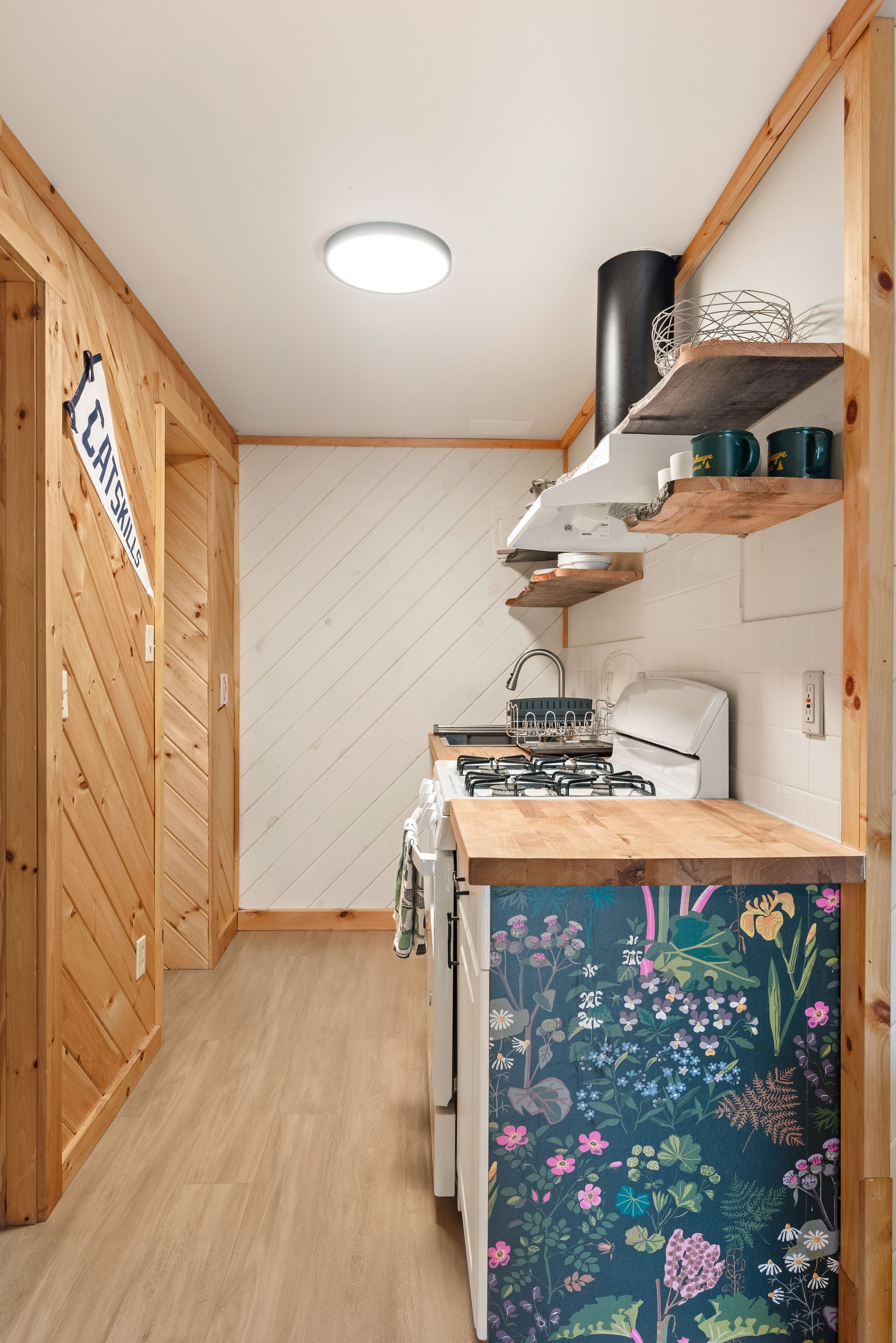 Cozy kitche for Cabin 4B in Belleayre Lodge in Pine Hill, NY, featuring stoves, wooden counters.