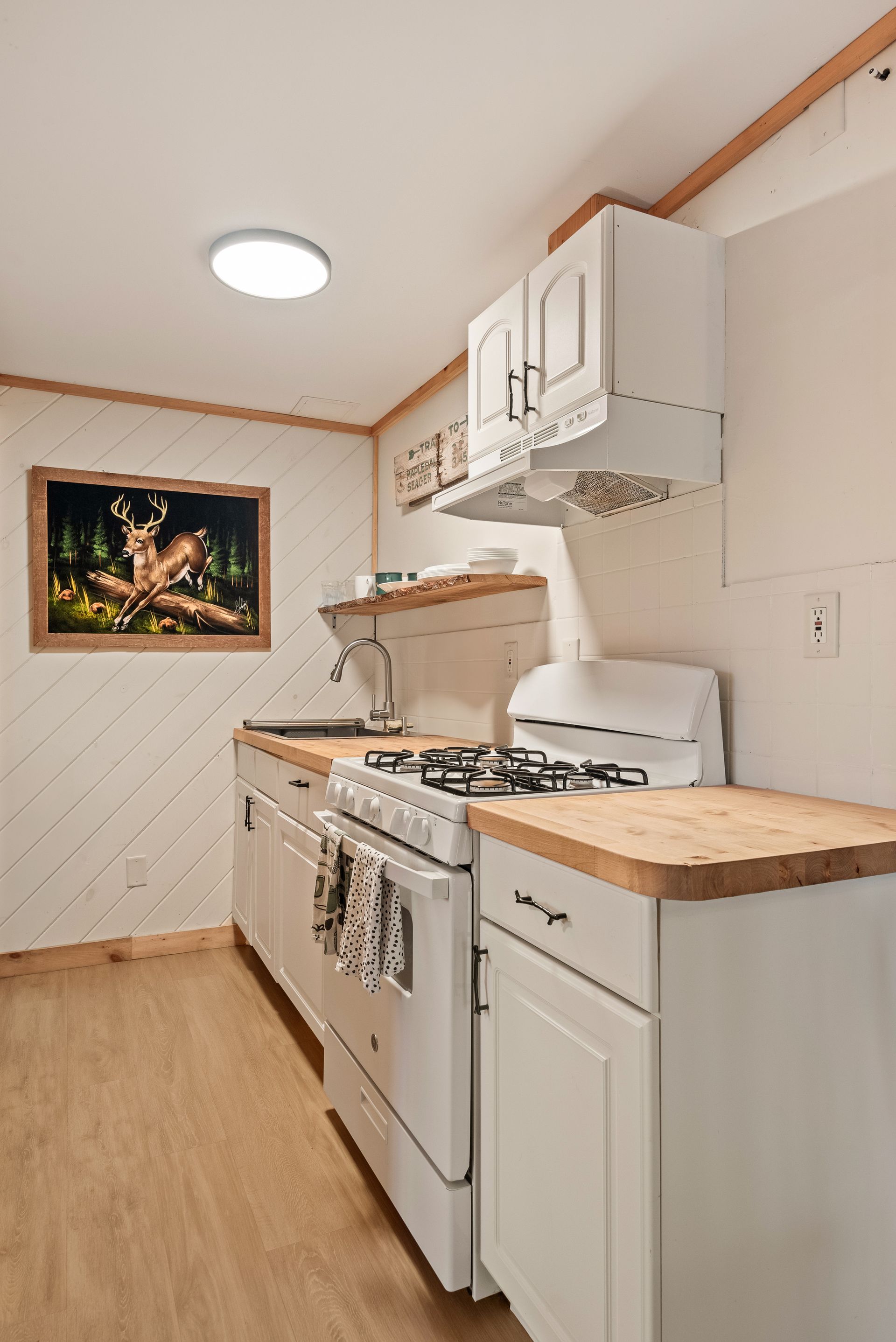 Cozy kitchen for Cabin 5B in Belleayre Lodge in Pine Hill, NY. Gas stove, wooden countertops.