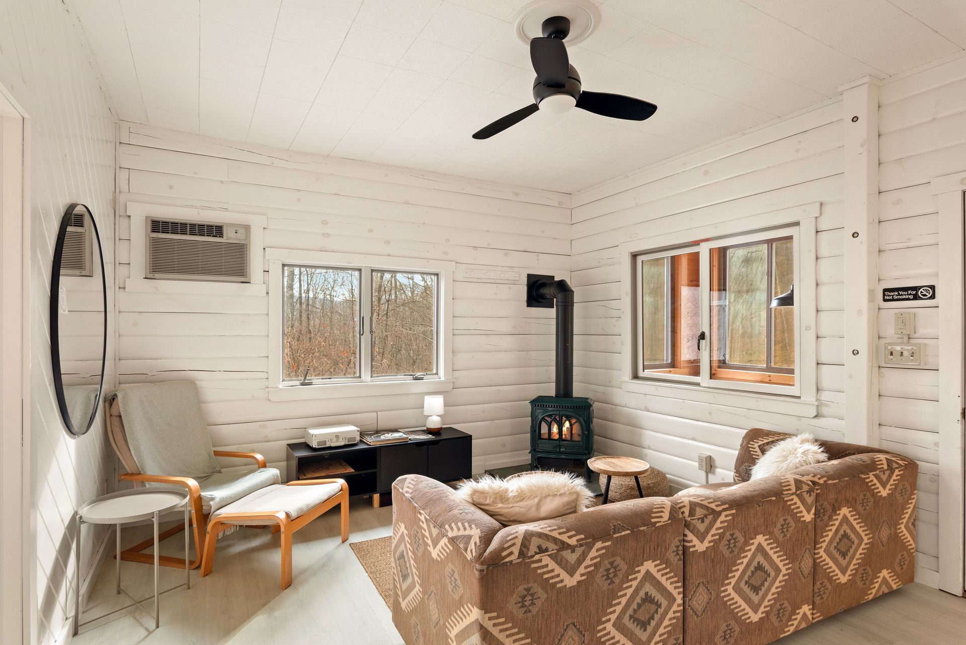 Cozy living space for Cabin 6 in Belleayre Lodge in Pine Hill, NY. Comfortable sofas, chairs, and gas fireplace