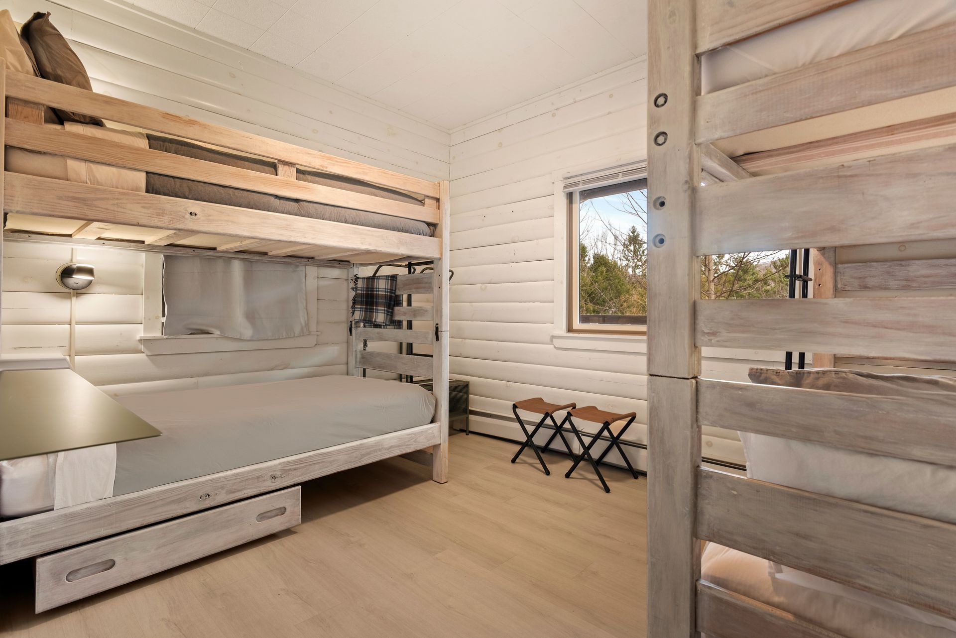 Cozy bedroom for Cabin 6 in Belleayre Lodge in Pine Hill, NY. Comfortable bunk beds and beautiful Catskills views out window.