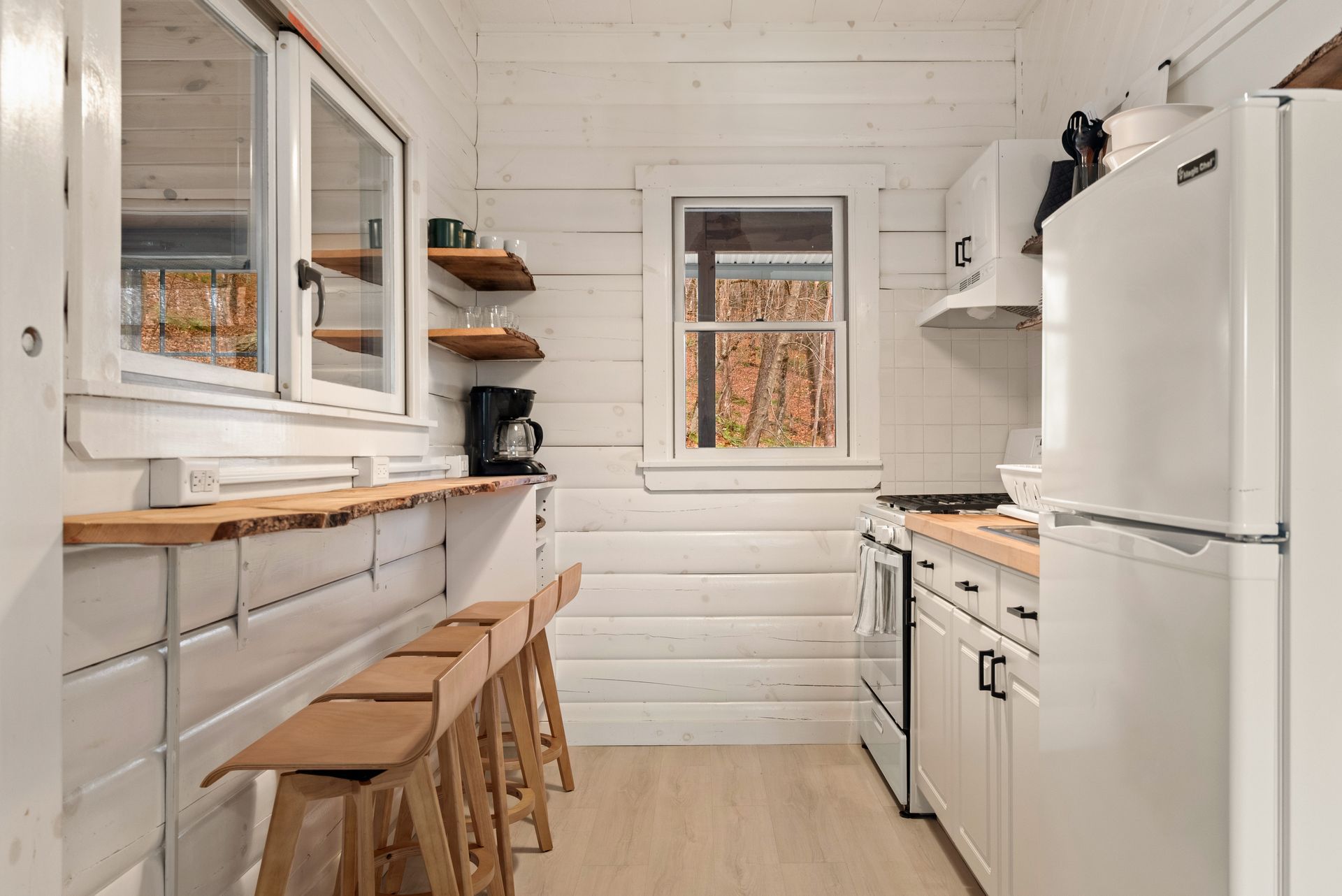 Cozy kitchen for Cabin 6 in Belleayre Lodge in Pine Hill, NY. Barstools, countertops, and kitchen appliances.