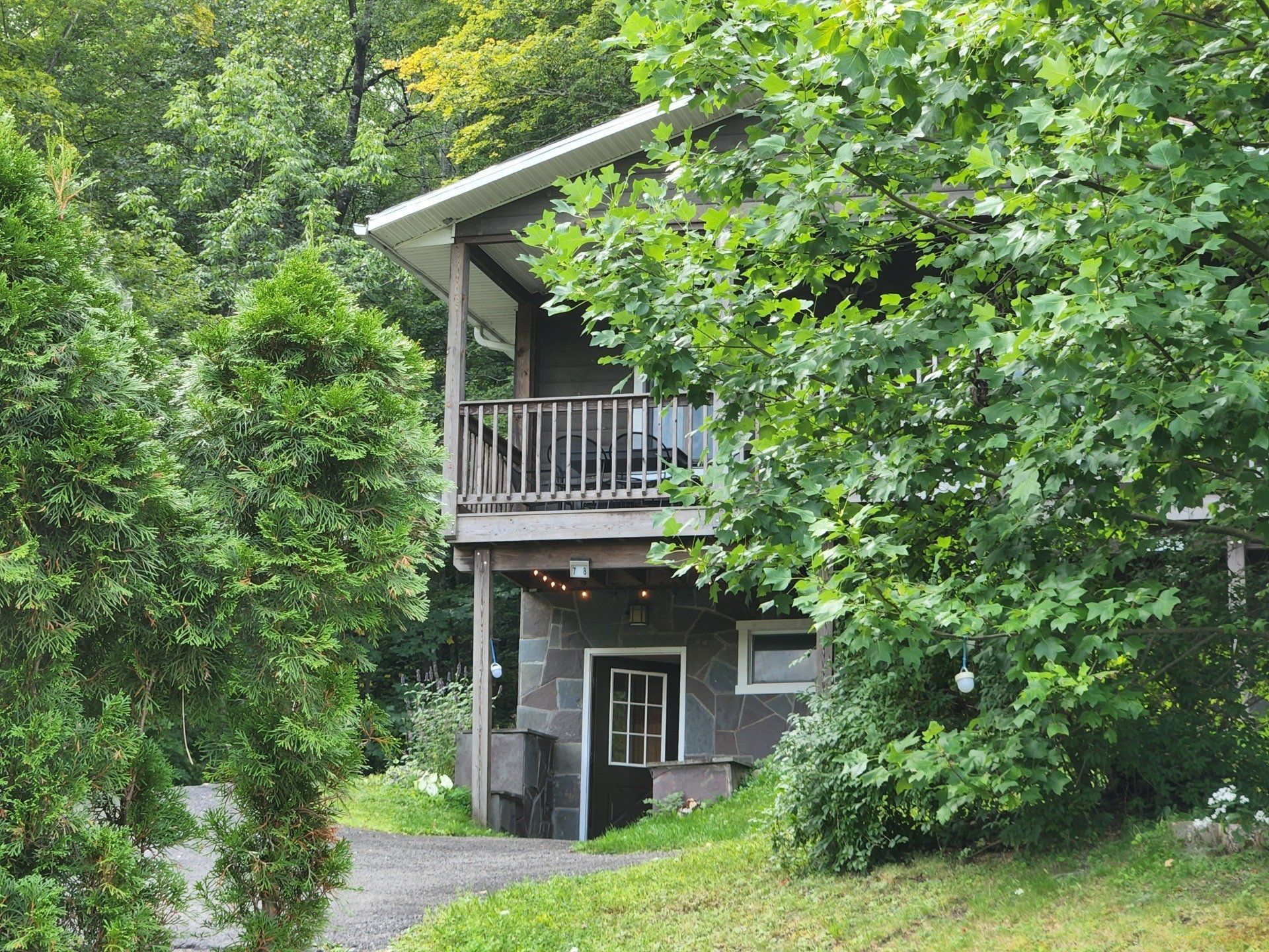 Exterior of Cabin #7 at Belleayre Lodge, seen through beautiful foliage.