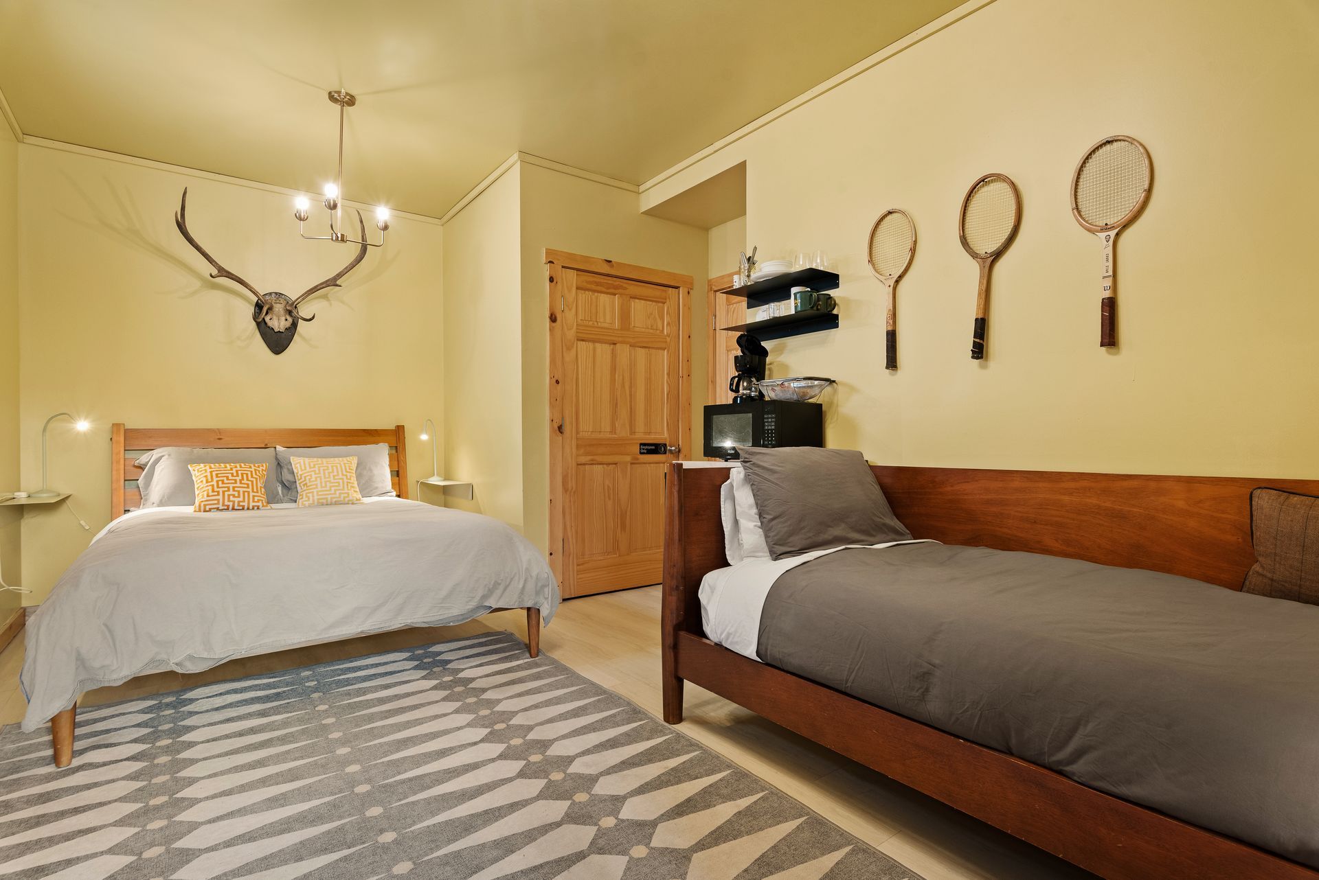 Cozy bedroom for Cabin 6 in Belleayre Lodge in Pine Hill, NY. Comfortable queen bed and wall decor