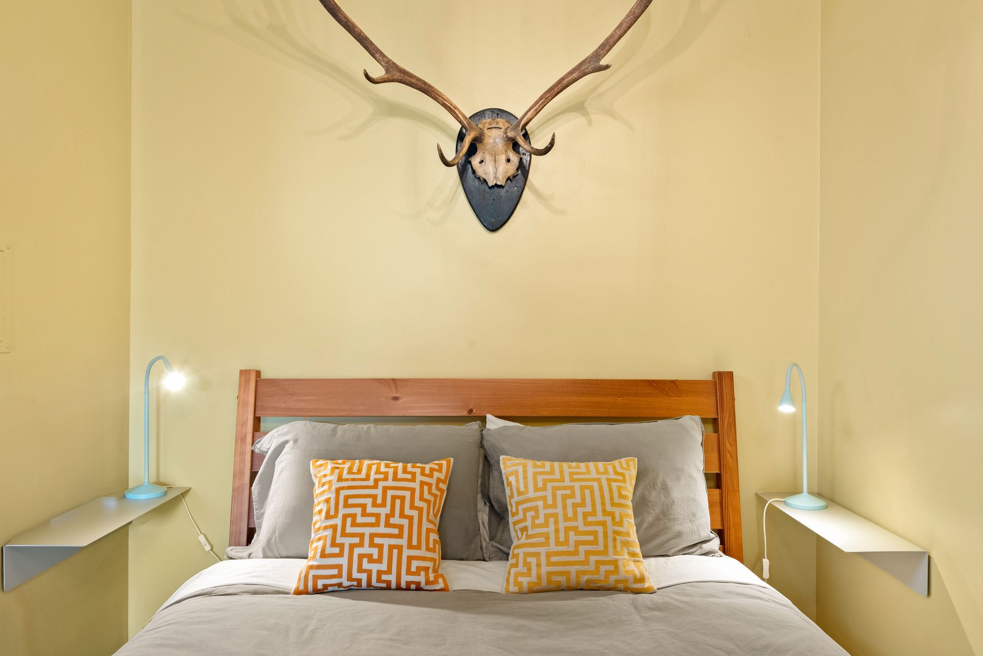 Cozy bedroom for Cabin 6 in Belleayre Lodge in Pine Hill, NY. Comfortable queen bed and wall decor