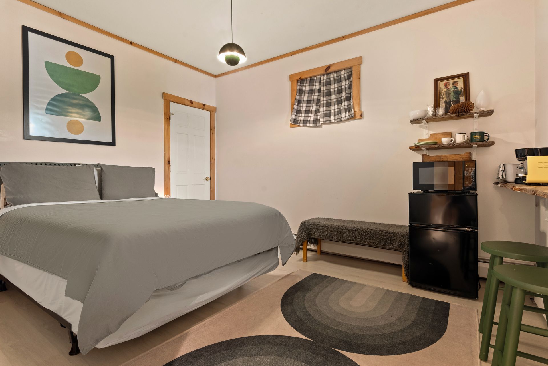 Cozy bedroom for Cabin 8 in Belleayre Lodge in Pine Hill, NY. Comfortable queen bed and wall decor