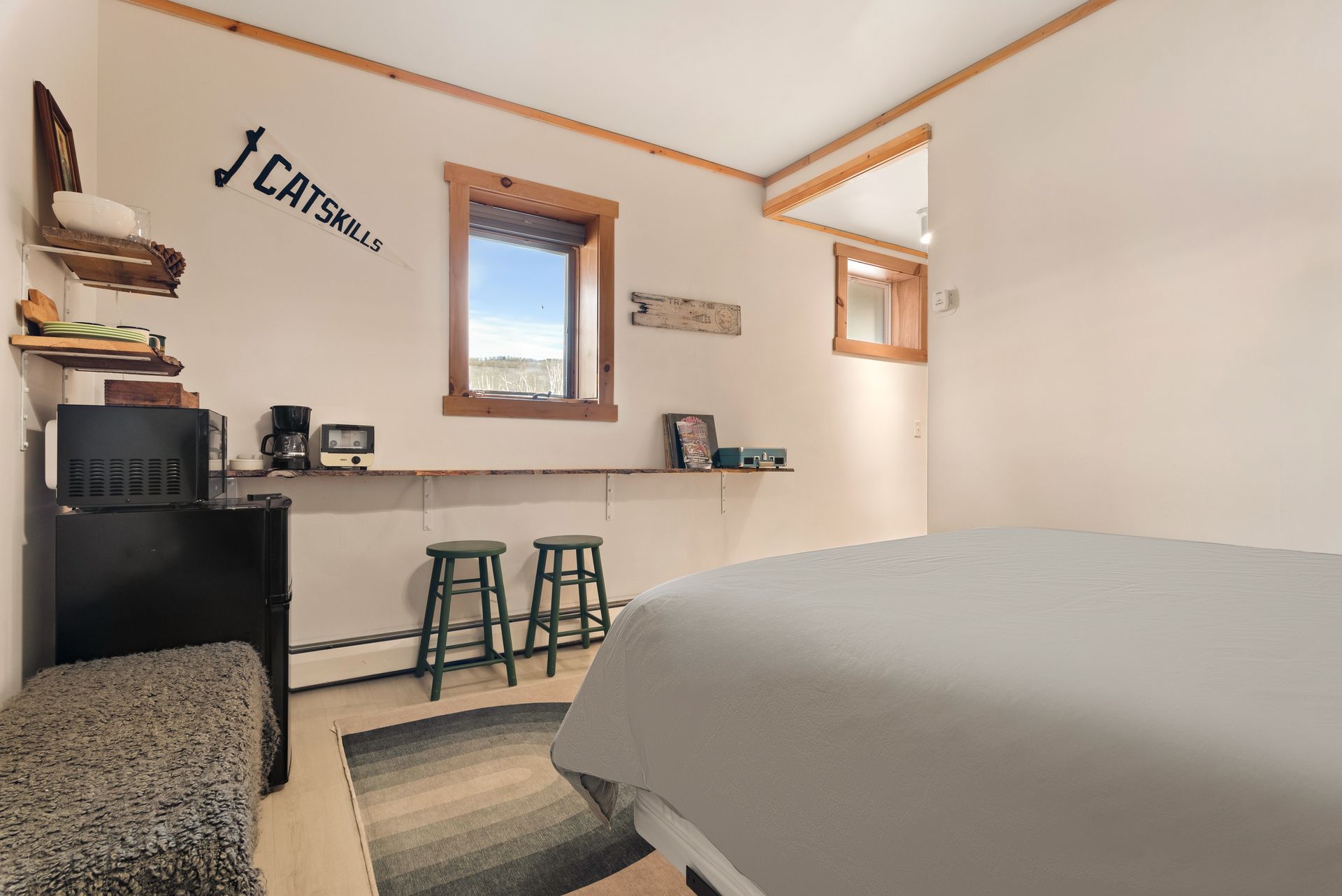 Cozy bedroom for Cabin 8 in Belleayre Lodge in Pine Hill, NY. Comfortable queen bed and wall decor