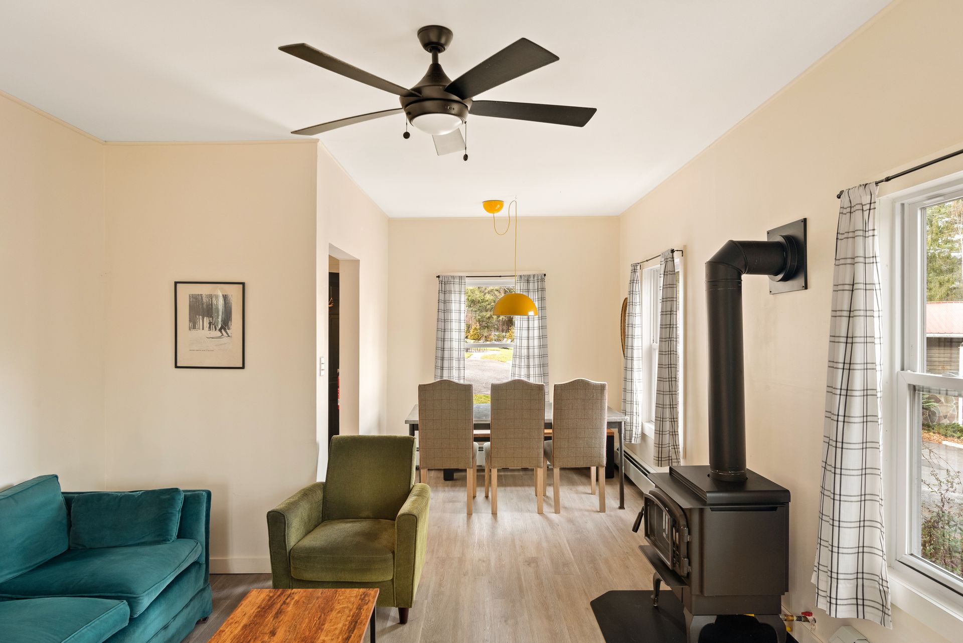 Cozy living room for Cabin 9 in Belleayre Lodge in Pine Hill, NY. Comfortable chairs and sofa, with wall decor