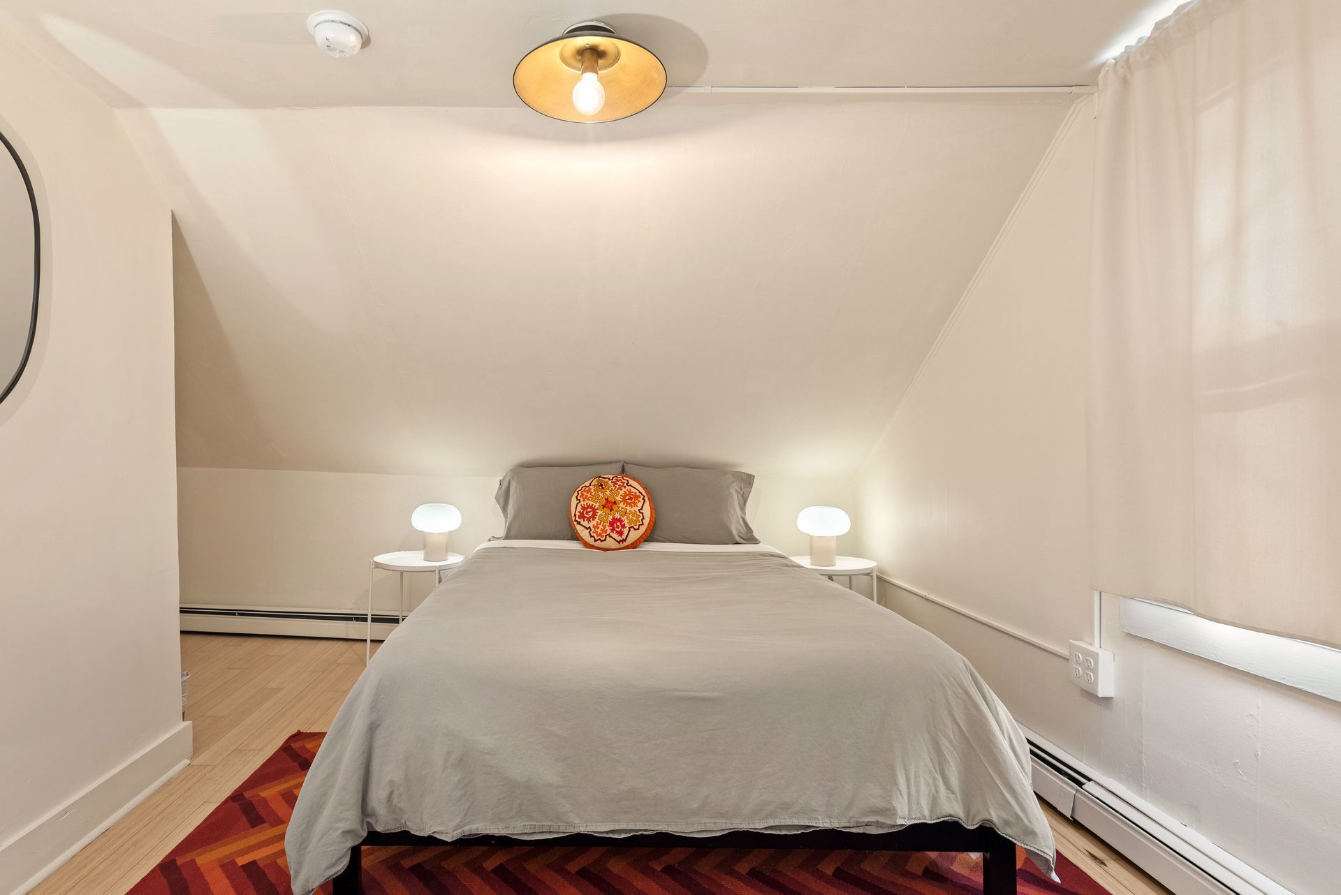 Cozy bedroom for Cabin 9 in Belleayre Lodge in Pine Hill, NY. Comfortable queen bed and wall decor