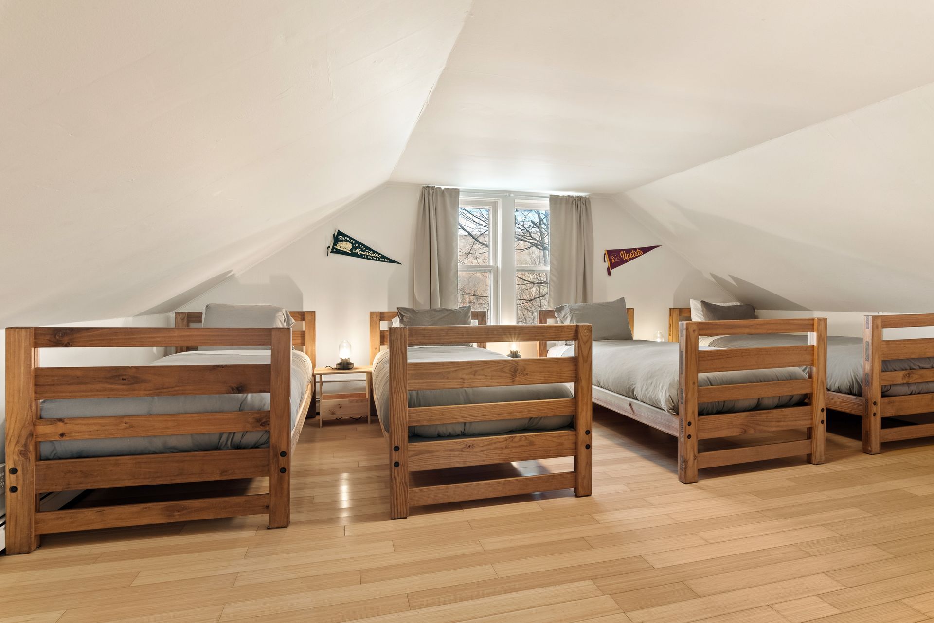Cozy bedroom for Cabin 9 in Belleayre Lodge in Pine Hill, NY. 4 twin beds and beautiful views of Catskills out window.