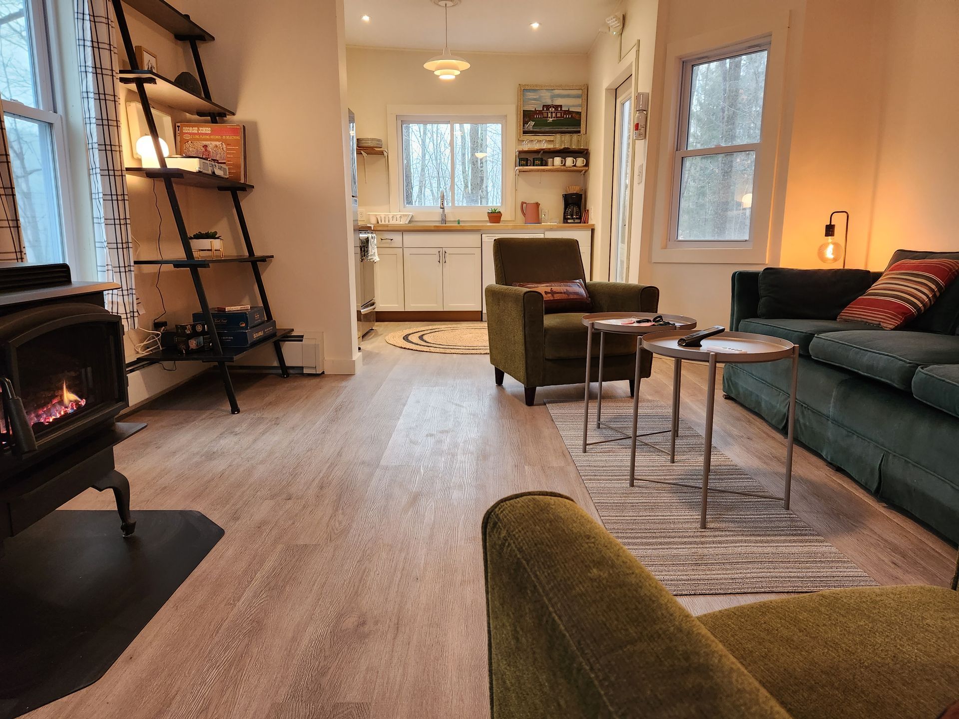 Living room space of Cabin #9 at Belleayre Lodge in the Catskills, showing sofa, tables, chairs, gas fireplace.