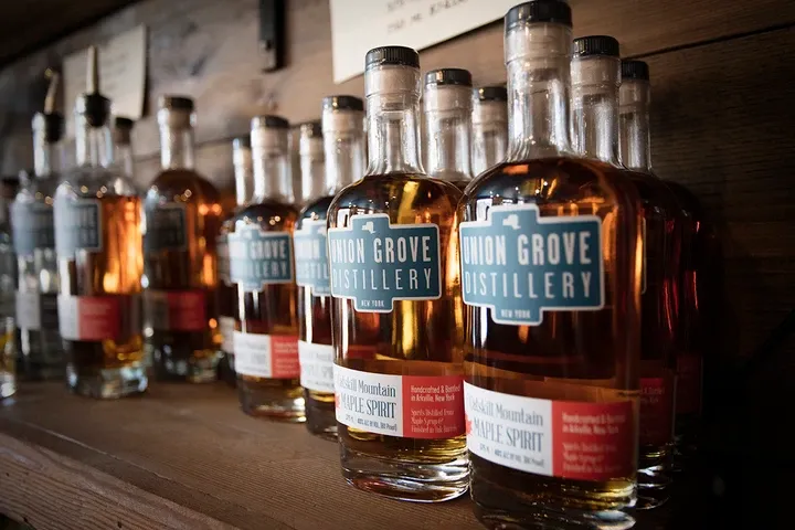 Interior of Union Grove Distillery, showing closeup of branded liquor bottels.