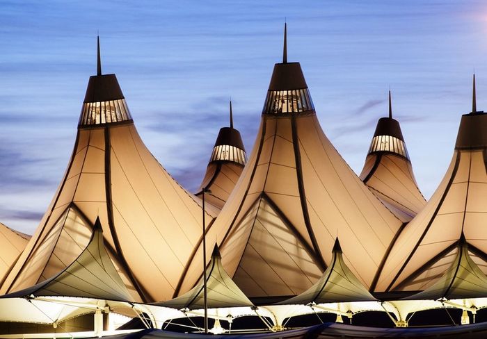 A row of tents with a blue sky in the background