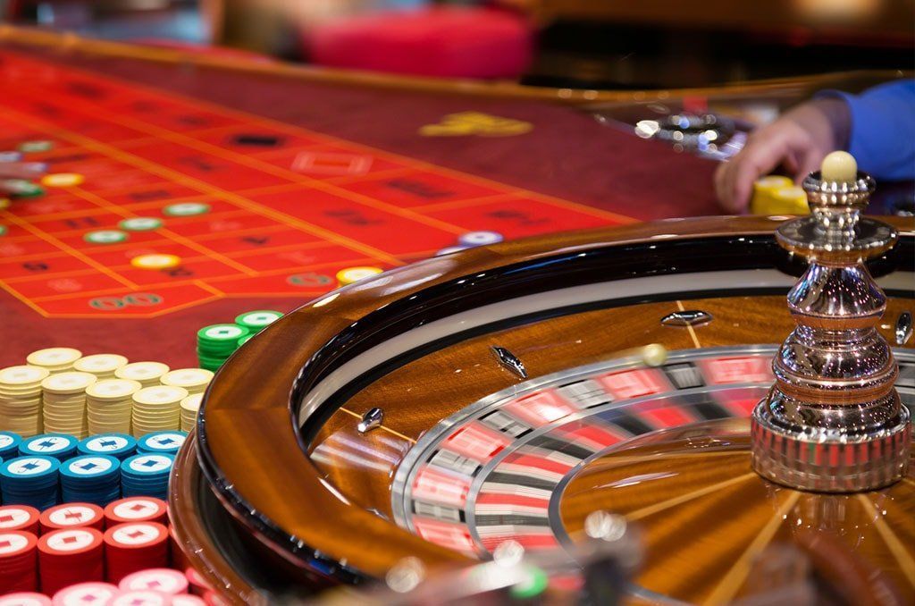 A person is playing roulette in a casino.