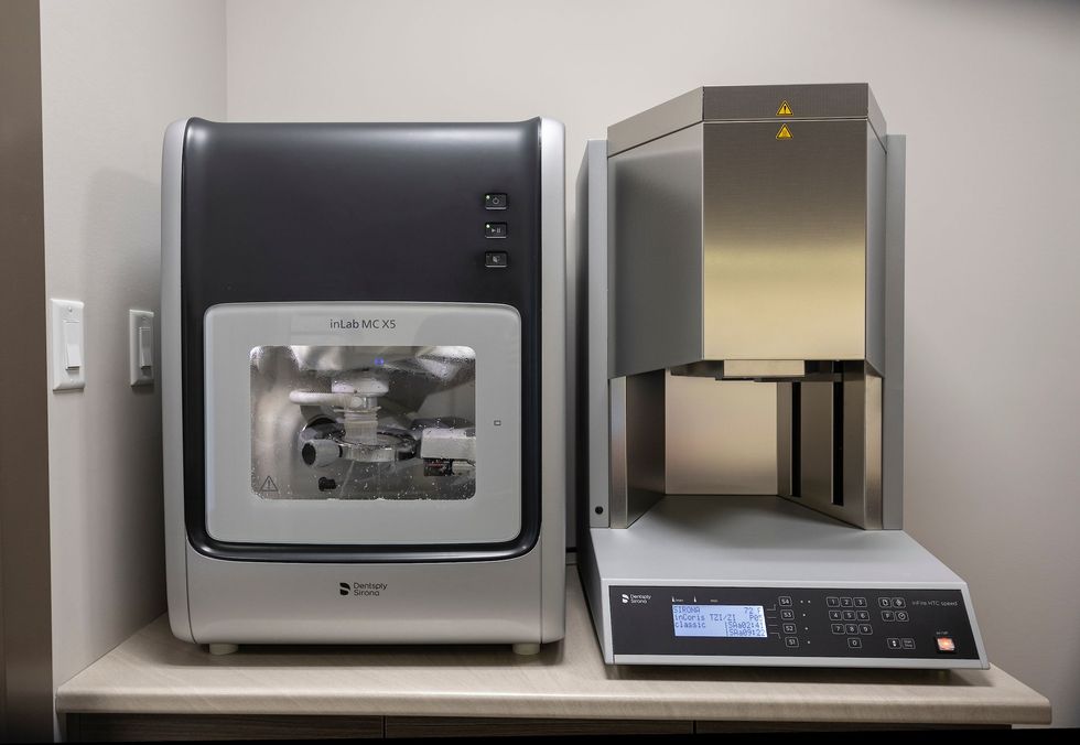 Dental milling machine and furnace on a counter in a dental office, for creating dental restorations.