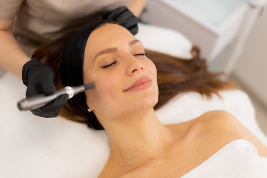 A woman is getting a botox injection in her face.