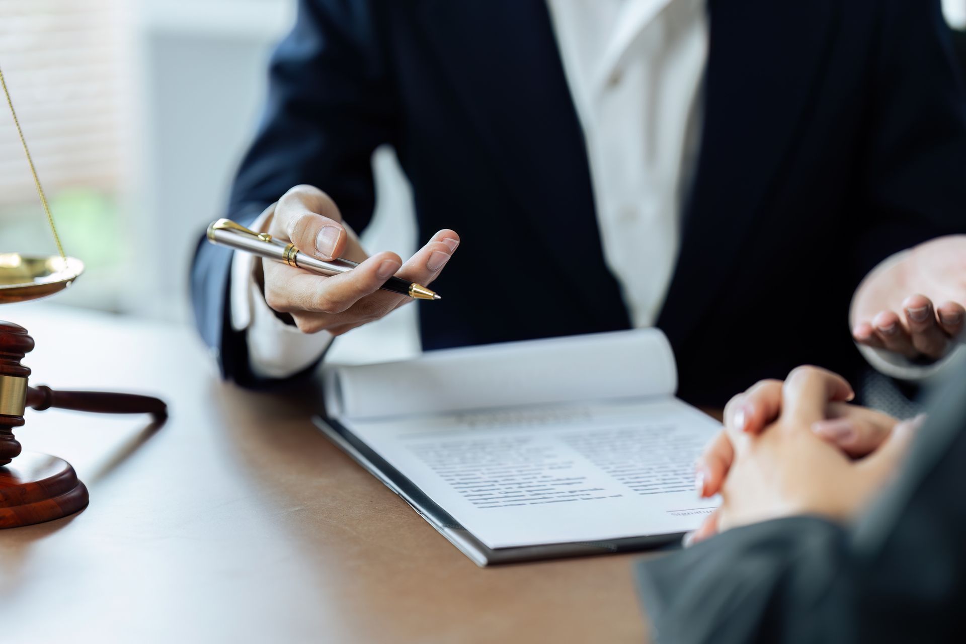 A family is sitting at a table signing a document.