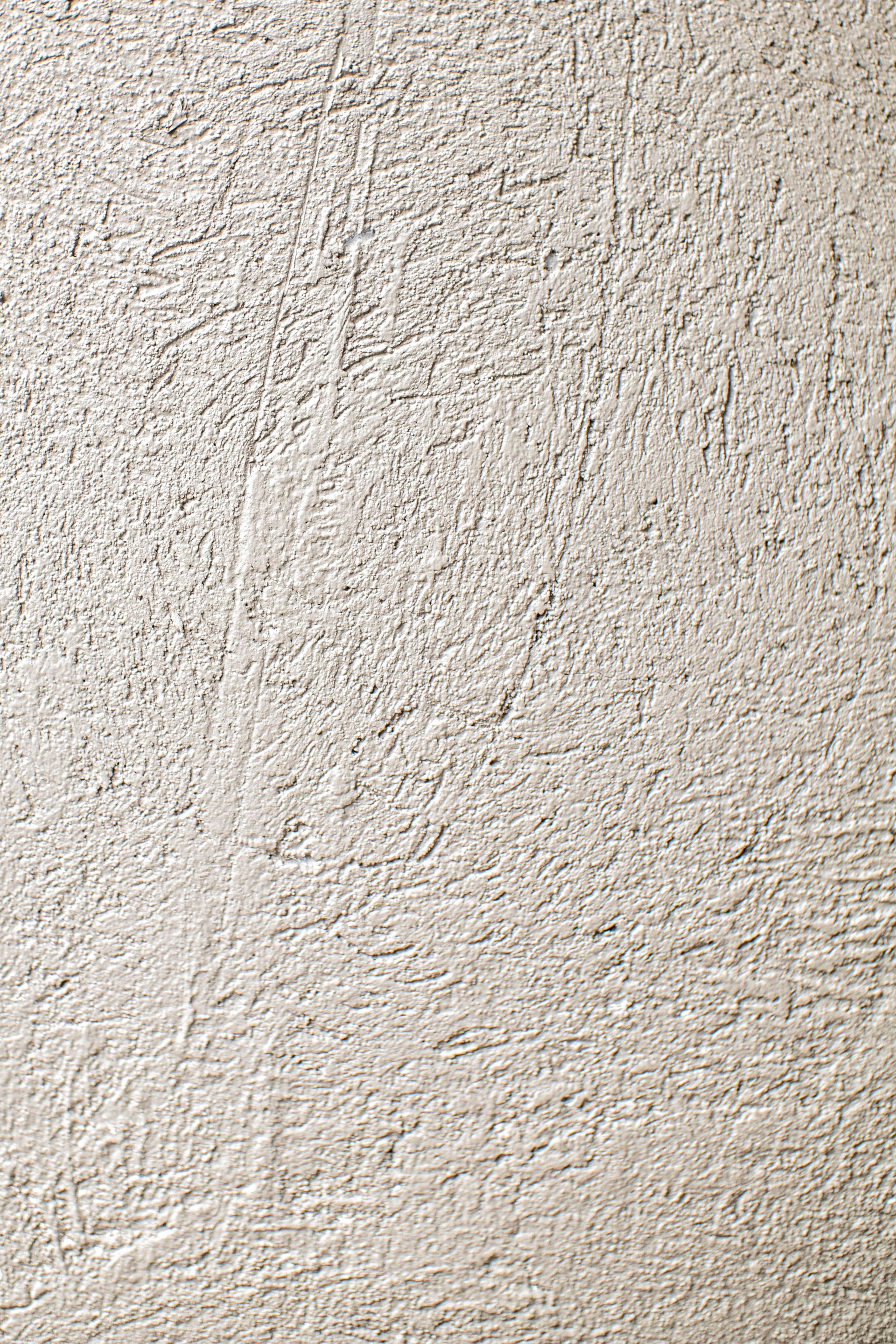 Close-up of a textured beige stucco wall surface