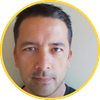 Close-up portrait of a man with a neutral expression inside a yellow circular border.