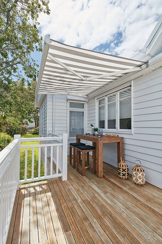 Outdoor Setting With A Pivot Arm Awning