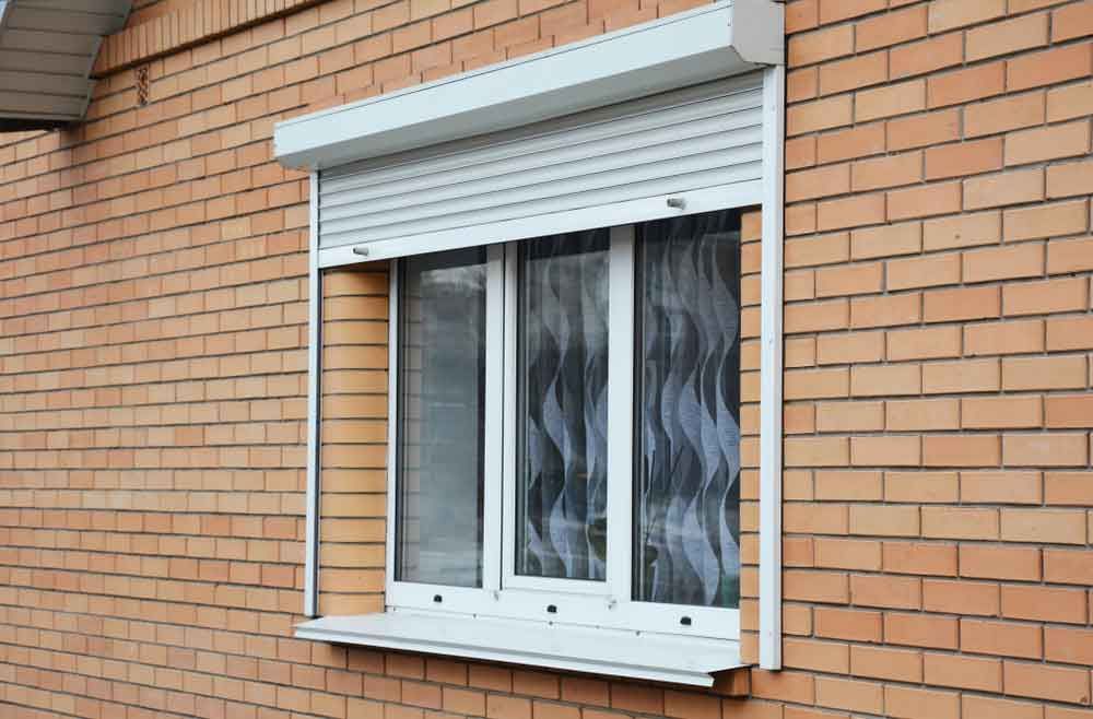 Rolling Shutters Brick House Window — Blinds in Bogangar, NSW